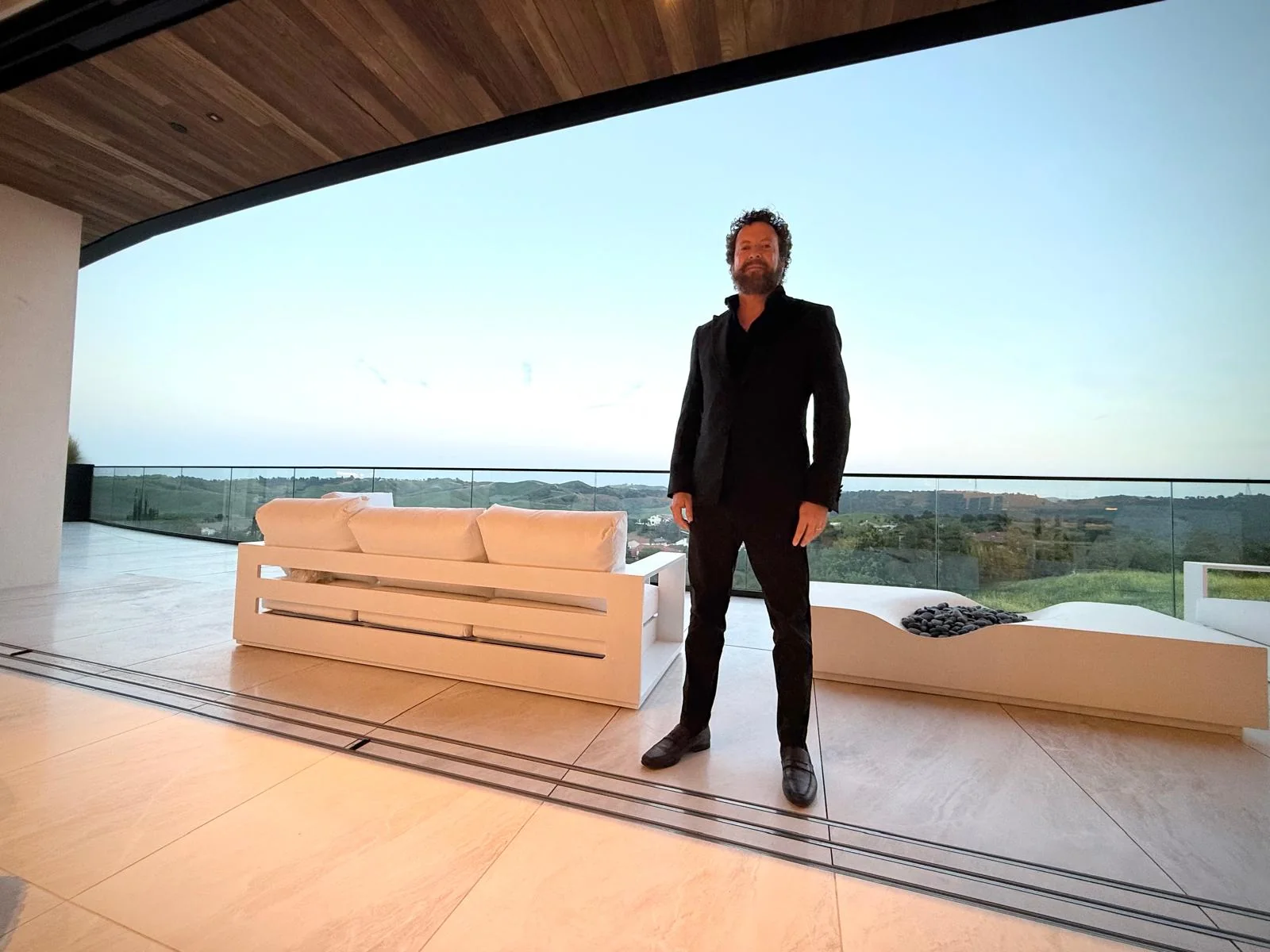 Winn Wittman on a hillside balcony at dusk