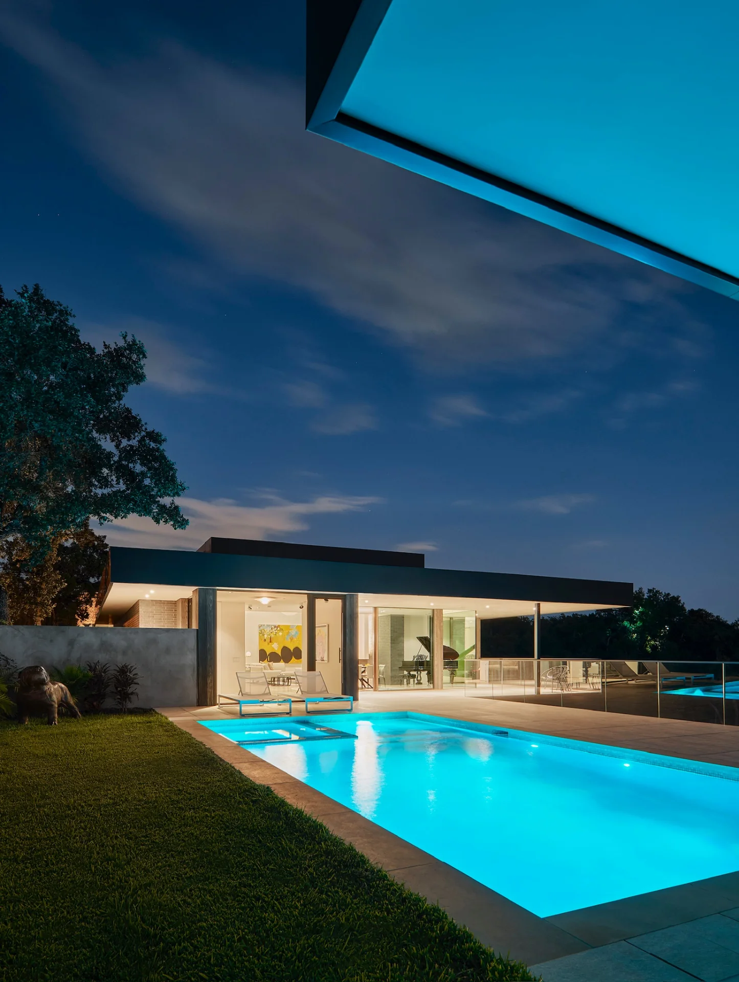 Modernist residence with pool at night